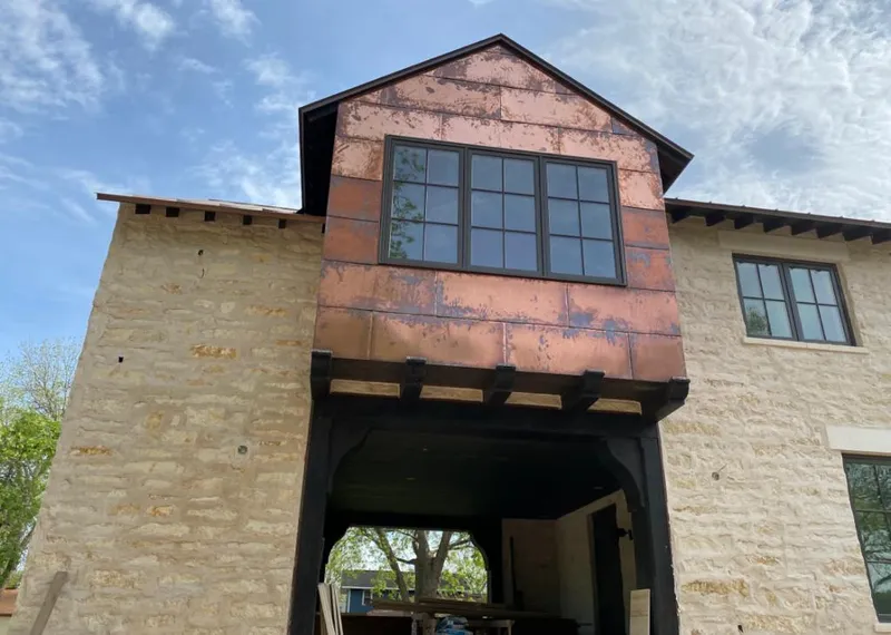 Copper metal panel facade on a stone building for Metal Roof Coating in Flowood
