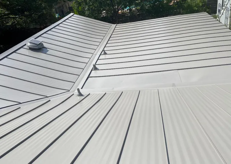 Solar attic fan installed on a metal roof for Roof Ventilation in Flowood